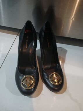 BCBGeneration Black Leather Pumps with Gold Medallion
